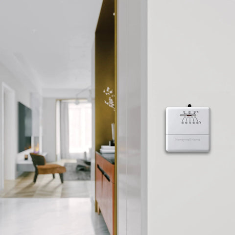 CT30A1005 Heat Only Manual Economy Thermostat Almond Finish 0.6 in wall-mounted in modern living room setting.