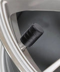 Heavy Duty 4 Pack Tire Valve Stem Caps For Tesla Cybertruck 2024 Through 2026 black anodized cap on tire valve image.
