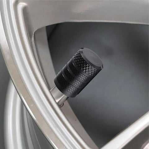 Heavy Duty 4 Pack Tire Valve Stem Caps For Tesla Cybertruck 2024 Through 2026 black anodized cap on tire valve image.