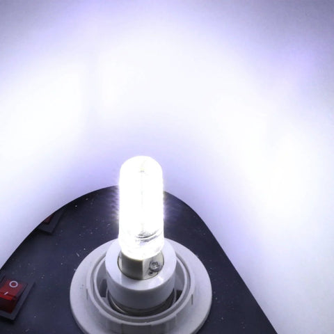 Close-up of illuminated tube light bulb in a socket with a white background, showcasing brightness and modern design.