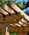 Wood pergola structure featuring hex cap nut covers for decorative finish