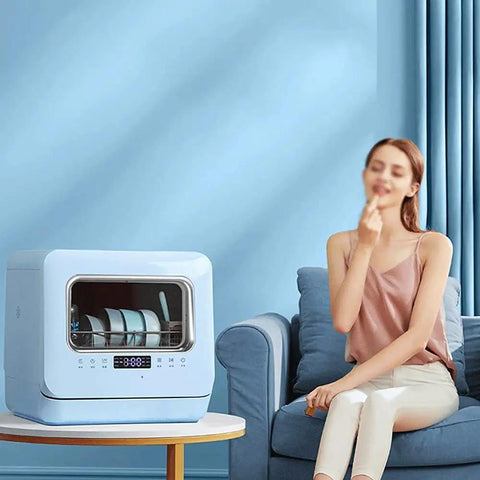 Pretty Slick Countertop Dishwasher Fully Automatic Stainless Steel With Six Place Settings LED Display And Delay Start Quick Connect Faucet Adapter Smooth Hassle Free Setup on a table in a modern living room.