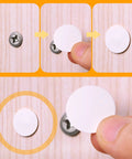 Plastic Self Tapping and Self Adhesive Screw Hole Covers for Wood Furniture being applied to a screw, showing placement on wood surface.