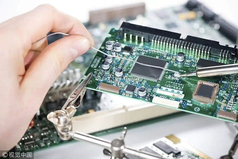 Hand soldering electronic circuit board with Sixty Forty Rosin Core Solder Wire 0.6mm tin lead for electronics repairs.