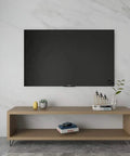 Living room setup with a TV stand featuring 10 Inch Trapezoid Hairpin Furniture Legs Set Of 4, Solid Cold Rolled Steel, Black Finish.