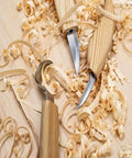 Premium Wood Carving Tools Kit Includes Hella Sharp Sloyd Knife And Hook Blade With Chip Carver resting on wood shavings.