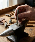 Hand using Pro Grade 20Pc 6Mm Steel Anvil Chisel Set for engraving on metal anvil, heavy duty jewelry stamping kit visible