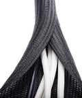 Sort Out Your Tangled Cords With This Durable 6.6 Foot Black Cable Sleeve One Inch Wide Wrap That Keeps Wires Organized And Safe From Chewing Pets On Computer Or Pc Setups, showing close-up of braided texture encasing multiple wires.