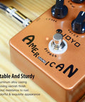 Golden-orange American Tube Amp Simulator And Preamp Guitar Pedal With Built In Cab Sim 6 Knob Tone Control on wood surface
