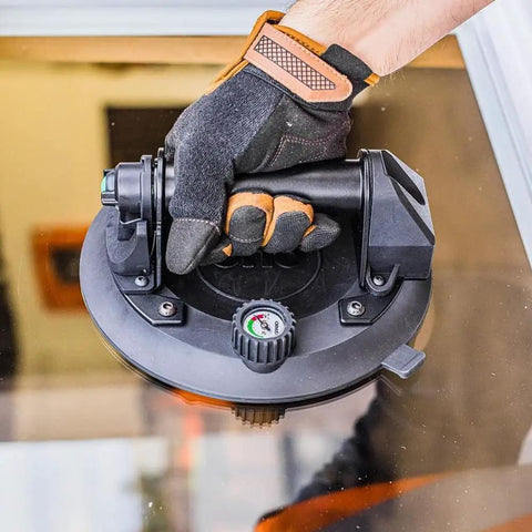 Hand using 8 Inch Electric Vacuum Suction Cup Heavy Duty Lifter For Glass Wood Drywall Granite Tile Sucker With One Button Start And Automatic Pump To Move Large Panels Up To 440 Lbs No Sweat on glass panel