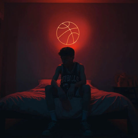 Basketball Neon Sign LED Light 11.8 Inch for Bedroom Decor, illuminating a game room with dope sports aesthetic above bed.