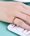 Hand wearing V Shaped Stainless Steel Wedding Band For Women With Chevron Pointed Design Engagement Promise Ring Simple Classic Gold Tone Size 6
