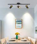 Dining room with Three Light Black Track Lighting With Rotatable Heads GU10 Ceiling Spotlights illuminating table