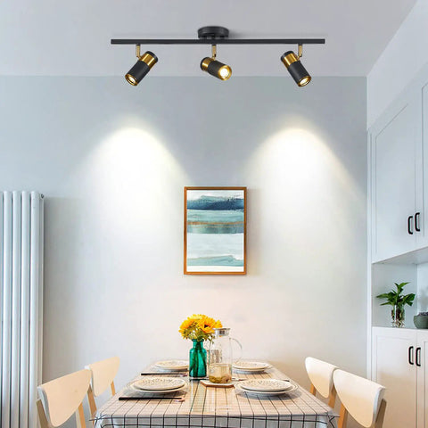 Dining room with Three Light Black Track Lighting With Rotatable Heads GU10 Ceiling Spotlights illuminating table