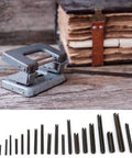 450 Piece Spring Steel Split Dowel Pins And Hollow Roll Pins Assortment Kit for Machine Repair, laid out with a vintage stapler.