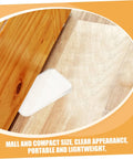 Clear Plastic Leveling Shims For Furniture Wobble Fix 32 Piece Wedge Set under wooden furniture leg on floor.