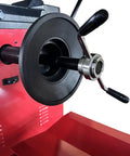 Close-up of the Shop Certified Wheel Balancer Engineered As The Dead Honest Workhorse For Giant 51 Inch Rims And Fleet Trucks Buses Blazing Eight Second Measurement Cycle 220V Operation, featuring a black rubber mount and chrome handle.