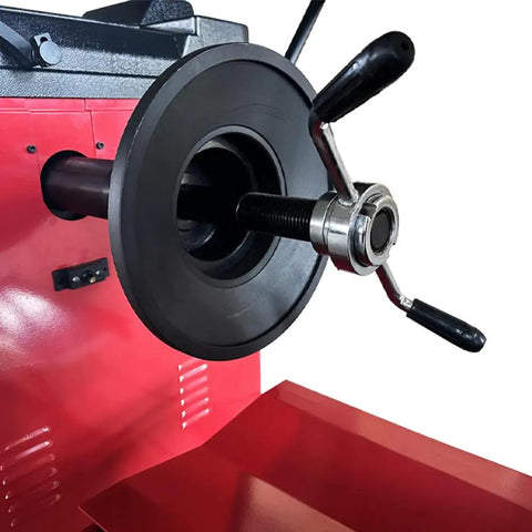 Close-up of the Shop Certified Wheel Balancer Engineered As The Dead Honest Workhorse For Giant 51 Inch Rims And Fleet Trucks Buses Blazing Eight Second Measurement Cycle 220V Operation, featuring a black rubber mount and chrome handle.