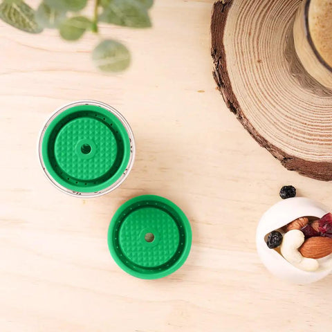 Top view of Reusable Coffee Pods And Discs For Nespresso VertuoLine And Vertuo Machines Rich Crema Version on wooden table.