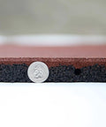 Close-up of Interlocked Outdoor Rubber Tiles 20x20 Inch 1 Inch Thick For Playground And Backyard Gym Flooring next to a coin