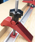 Close-up of Rock Solid Aluminum T Track Hold Down Clamps for Woodworking and Metalworking Projects, showing black knob and metal rail.