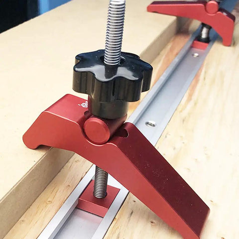 Close-up of Rock Solid Aluminum T Track Hold Down Clamps for Woodworking and Metalworking Projects, showing black knob and metal rail.