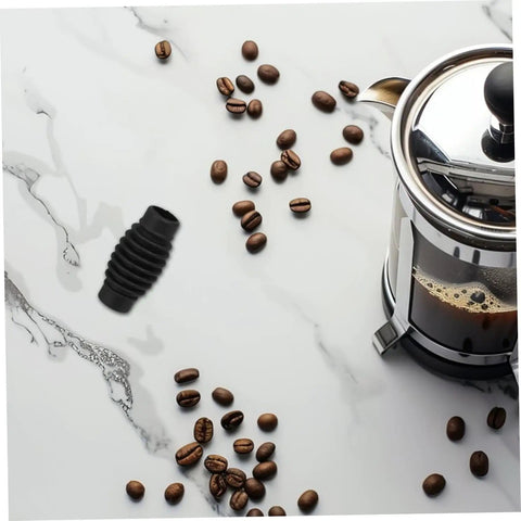 Dope Steam Wand Guard For Espresso Machines, Heat Insulation Pad next to coffee beans and a coffee maker on marble surface.