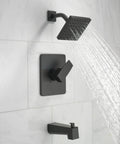 Dope Modern 14 Series Square Bathtub And Shower Faucet Set In Matte Black installed on white tile, water flowing from shower head.