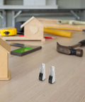 Killer Durability Heavy Duty Sliding Door Track Pulley Roller Set With Zero Friction Silent Glides on a wooden table with tools.