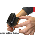 Close-up of hands inserting a new pad into a Slick Self Inking Micro Message Dater Stamp With Quick Flip Phrases For Office Organization And Zero Mess Record Keeping Is A Legit Daily Go To Business Supply Staple.