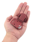 16 Pieces Plastic Red Cabinet Sliding Door Pulley With Screws Wardrobe Roller Track Gear Panel Interior Kit held in a hand