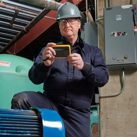 Technician using PTi120 Pocket Thermal Imager For Quick Infrared Inspections And Temperature Scans On The Go in industrial setting
