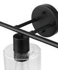 Close-up of light fixture from Bristol 5 Piece All In One Matte Black Bathroom Set With Dimmable 3 Light Vanity Light Featuring Seeded Glass Shades