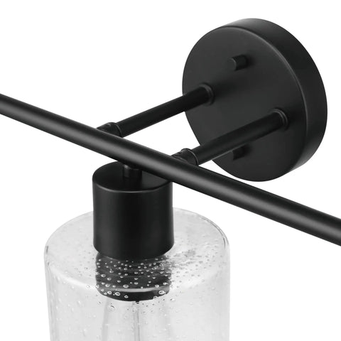 Close-up of light fixture from Bristol 5 Piece All In One Matte Black Bathroom Set With Dimmable 3 Light Vanity Light Featuring Seeded Glass Shades