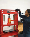 Woman operating a 20 Ton Hydraulic Shop Press for Gear Bearing and Bushing Removal Straightening and Bending Heavy Duty Industrial Grade Beast.