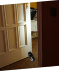 Heavy Duty Sliding Door Track Roller Wheels Four Pack Glides Smooth With Zero Drag Barn Door Hardware mounted on a door.