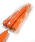 Compact Horizontal Flow Wrapper Shrink Wrap Machine 50 To 80 Pieces Per Minute wrapping fresh carrots in clear plastic packaging.