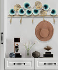 Slick Leaf Design Wall Mounted Coat Rack For Entryway Door with heavy duty hooks, displaying a hat and decorative items.