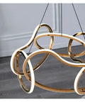 Close-up of Modern Stainless Steel Creative LED Pendant Lamp, luxury minimalist design with gold accents, ideal for decor.