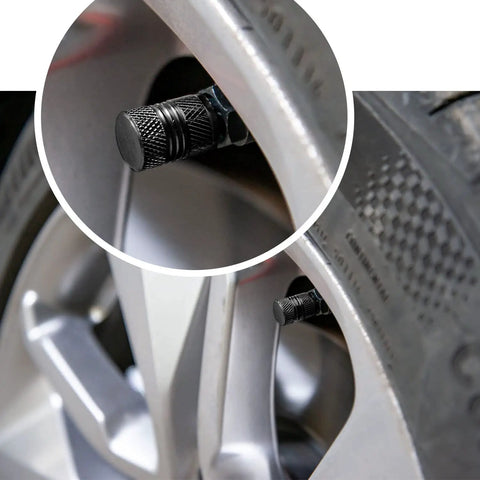 Premium Alloy Tire Valve Stem Caps 8 Pack Corrosion Resistant And Leak Proof Air Caps For Car SUV Truck Motorcycle And Bike Universal Fit Black on silver alloy wheel close-up.