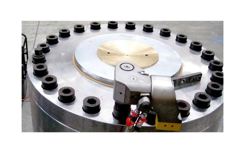Adjustable Hydraulic Torque Wrench With Two Point Five Inch Square Drive And Precision Aluminum Build For Heavy Duty Industrial Fastening, shown fastening a large flange.