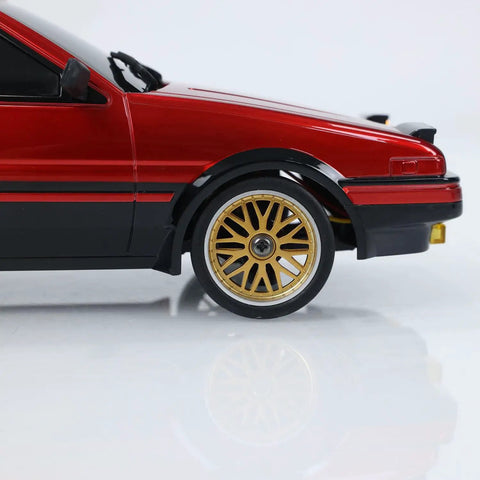 Close-up of One Eighteen Scale RC Drift Car With Gyro Stabilization In Vintage Red showing gold wheels and detailed side view