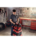 Man organizing tools in VersaStack Zippered Tool Bag With 31 Pocket Organizer Built For Heavy Duty Hauling Durable 1680 Denier Fabric
