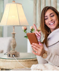 Cozy Farmhouse Style Table Lamp With Touch Control And 3 Way Dimming next to woman using phone on beige sofa