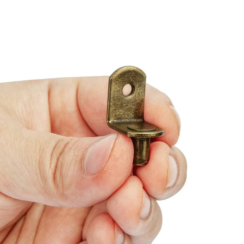 Premium L Shaped Cabinet Shelf Clips With 6mm Holes 40 Pack Bronze Metal Support Peg held in hand, showing detail of peg design.
