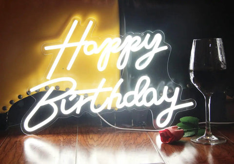 LED Neon Happy Birthday Sign Night Light For Party Backdrops And Bedroom Wall Decor, USB Powered White Glow, beside a wine glass