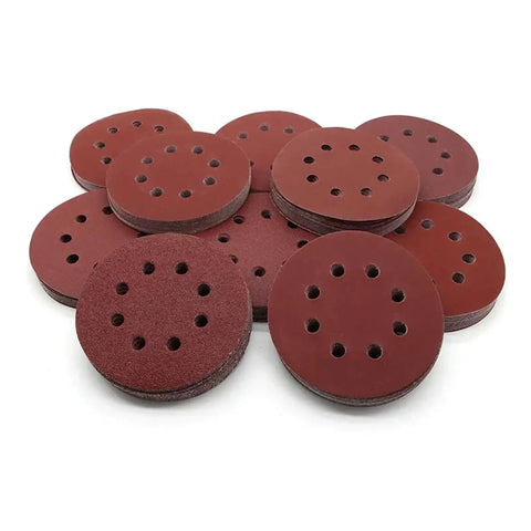 Premium 5 Inch Hook And Loop Sanding Discs With 8 Holes For Random Orbital Sanders stacked in a pile, featuring vibrant buffing wheels.