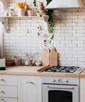 White kitchen with brick wall, light wood countertop, and white cabinetry featuring Antique Brass Cabinet Pulls Set Of 6 For Kitchen And Dresser Solid Zinc Alloy Drawer Handles Vintage Industrial Vibe With Straight Bar Hardware And Flat Base 3 Inch Hole Center Cool Rustic Modern Upgrade.