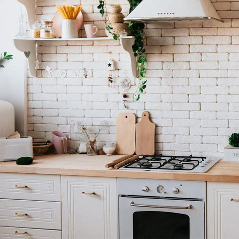 White kitchen with brick wall, light wood countertop, and white cabinetry featuring Antique Brass Cabinet Pulls Set Of 6 For Kitchen And Dresser Solid Zinc Alloy Drawer Handles Vintage Industrial Vibe With Straight Bar Hardware And Flat Base 3 Inch Hole Center Cool Rustic Modern Upgrade.