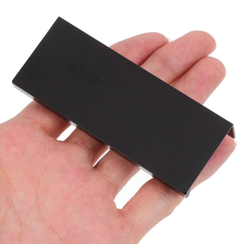 Slick Matte Black Recessed Cabinet Handles Edge Pulls for Sliding Doors and Drawers Hidden Flush Finger Pulls shown in hand for scale.
